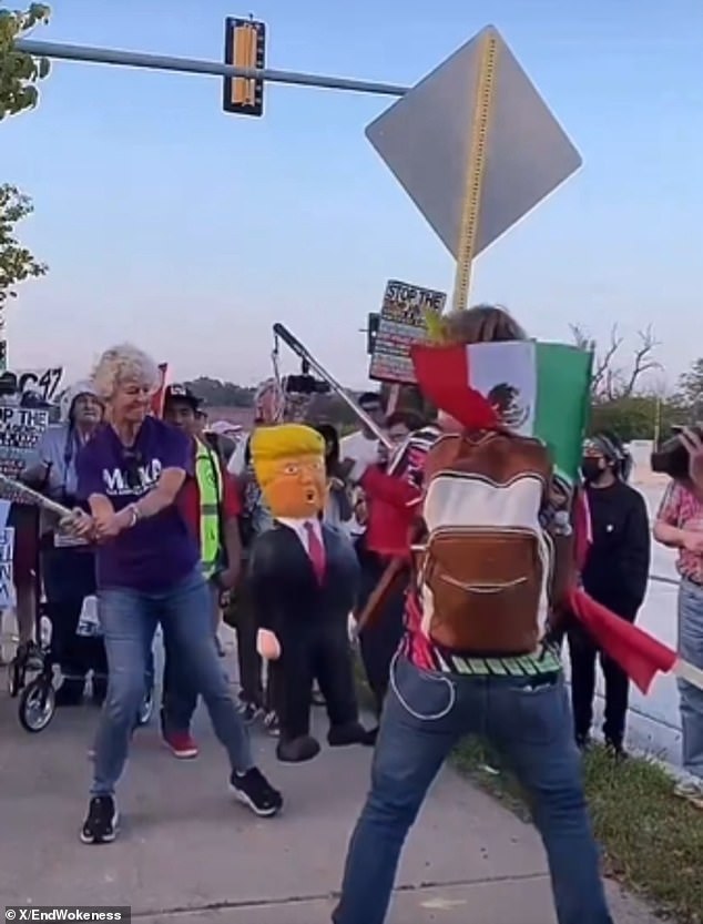 Protester strikes piñata of Trump while wearing 'Make America Kind Again' shirt