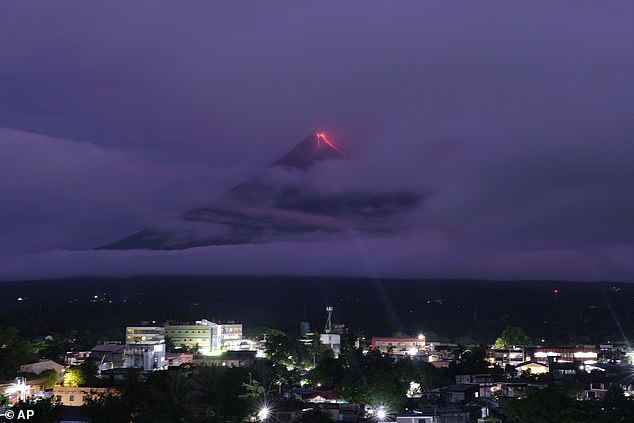 Green meteor streaks sky above Mount Mayon volcano in Philippines
